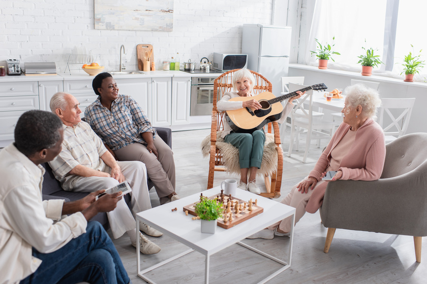 Woman playing guitar for group